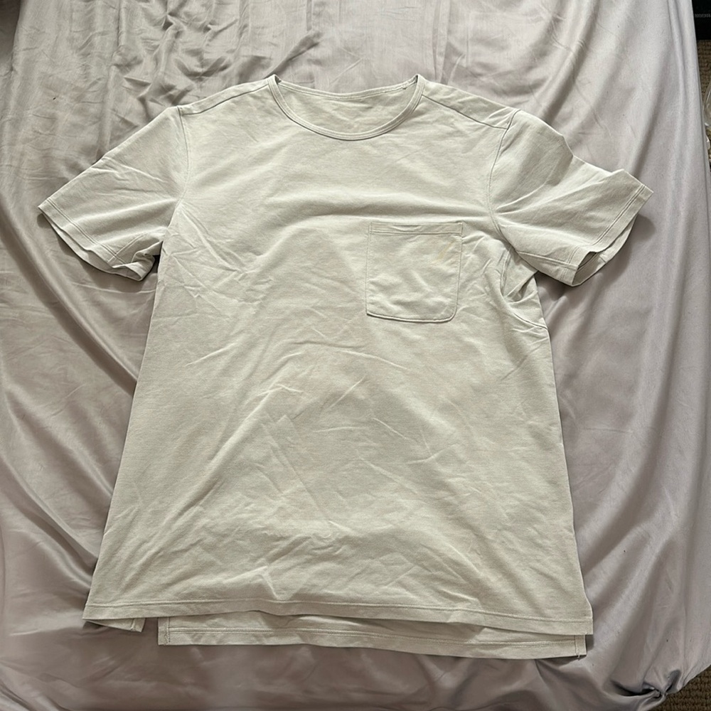 Linen cream colored tee with yellow stain on front pocket